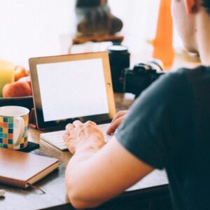 man writing on a computer