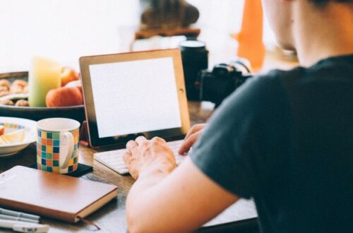 man writing on a computer