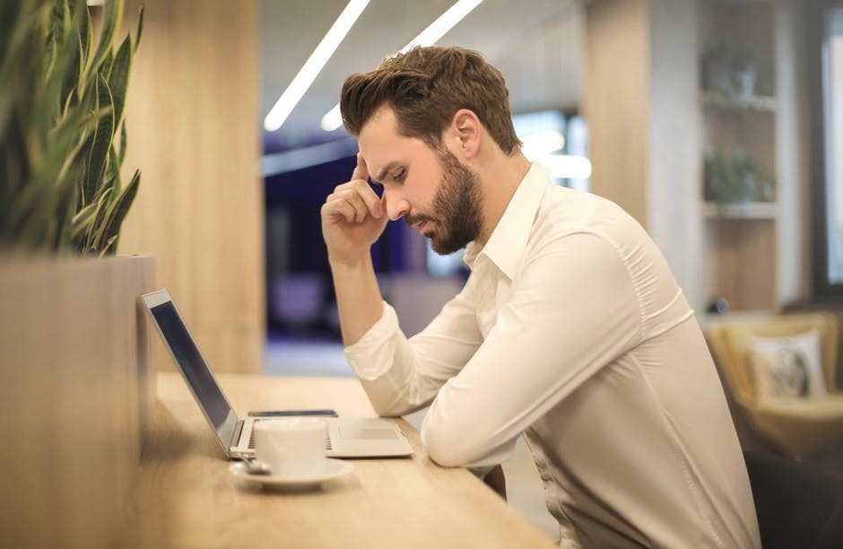 moan working at a computer writing a novel