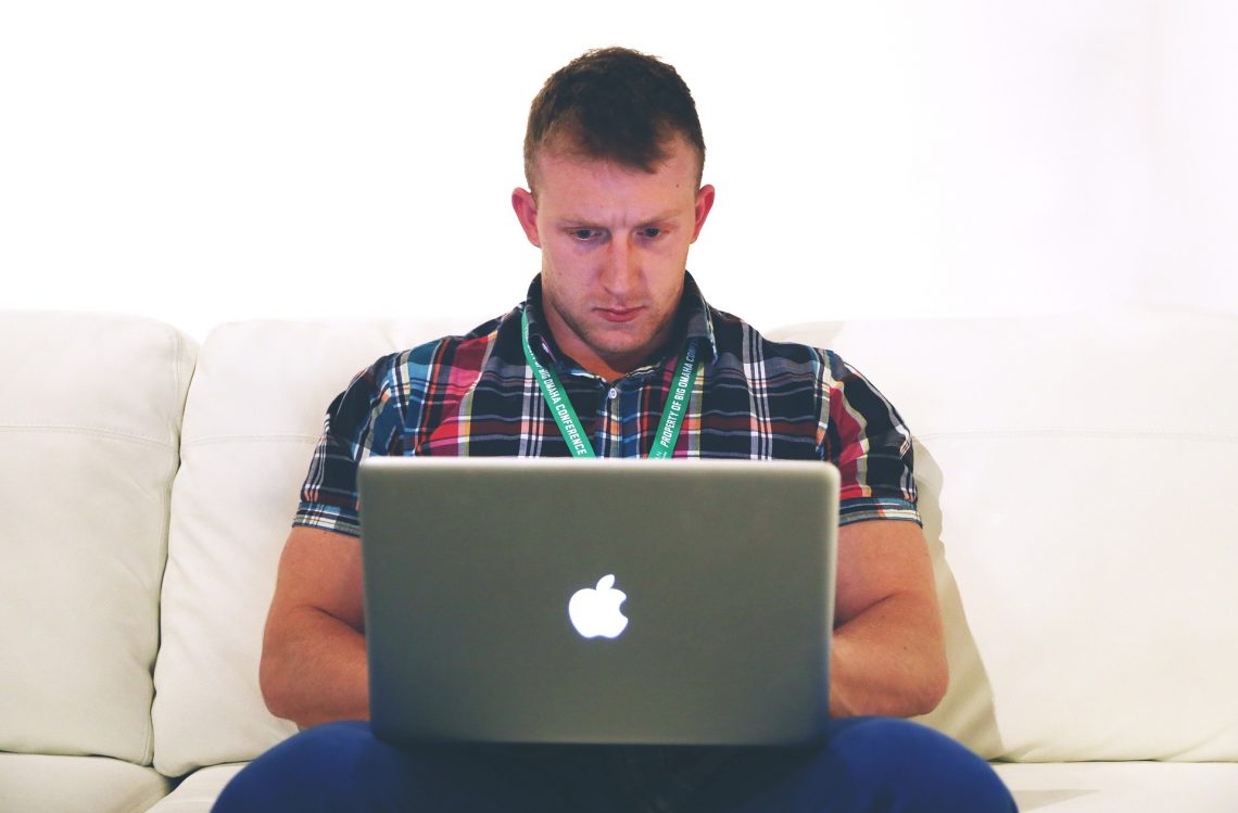 man typing on computer